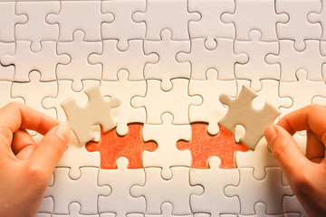 two Hand put the last piece of jigsaw puzzle to complete the mission.,Business strategy concept.