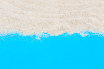 Fototapeta na wymiar Sand on blue background. Copy space for text.