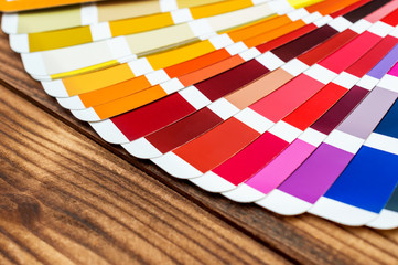 Color swatches book on the wooden table. Close up.