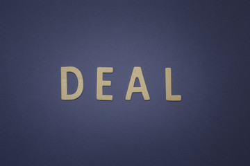 Deal written with wooden letters on a blue background