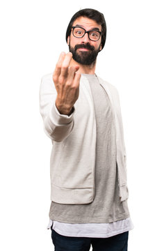 Hipster man doing coming gesture on white background