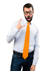 Funny man with glasses making rock gesture