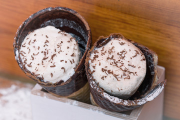 Ice cream in a horn with chocolate