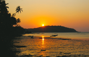 India. Goa. golden sunset on the river chapora.