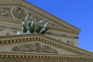  Fragment of the Fronton of the Moscow Big Theater with a quadriga of Apollos and a two-headed eagle on a sunny day.( Bolshoi Theater)  Moscow.