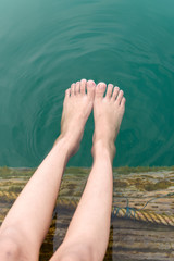 Dit the foots in the green water in natural