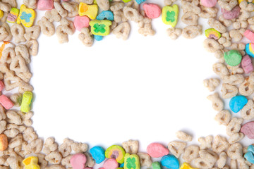 Fototapeta na wymiar Frosted toasted oat cereal with fun shaped marshmallows on white background.