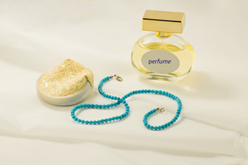 Perfume, jewelry and cosmetic bag. Women things. Beads. Necklace