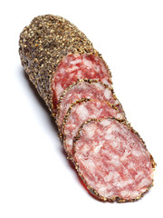 Dried organic salami sausage covered with pepper on white background