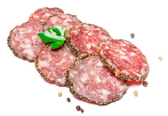 Dried organic salami sausage covered with pepper on white background