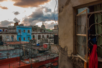 Evening landscape. Top view of the street, on ordinary houses with roofs and balconies, where clothes dry. Havana. Cuba