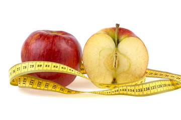 apple and measuring tape on white background