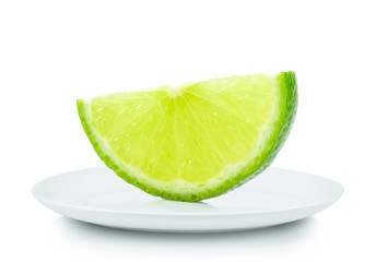 Piece lemon in white plate on white background