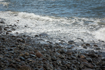 Stony beach in Funchal on Madeira island, Portugal