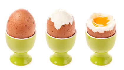 Egg in egg cup isolated on white