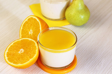 Food. Panna cotta. Italian milk citrus dessert made of yoghurt and cream with pear and orange.