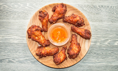 Baked chicken wings with sesame and sauce. Food background. Top view