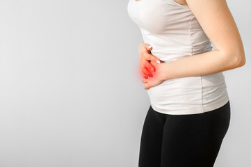 Woman with hands holding stomach. Medical or gynecological problems, healthcare concept