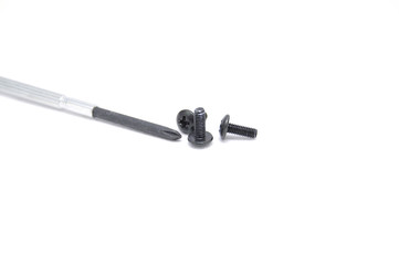 Screws and screwdriver on white background closeup