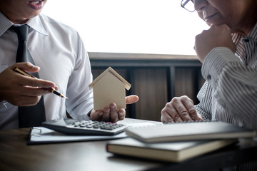 Real estate broker agent being analysis and making the decision a home estate loan to customer,...