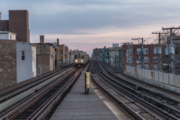 Fototapeta na wymiar Looking down elevated tracks as a train approaches