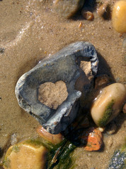 Stone with heart on the sand
