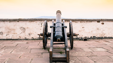 Fototapeta na wymiar The old iron cannon in Palanok Castle, Mukacheve. Palanok Castle - one of the oldest Ukrainian fortresses in Mukacheve. Toning