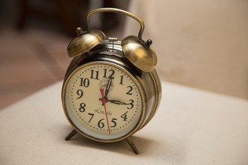 close-up of an ancient alarm clock in bronze color
