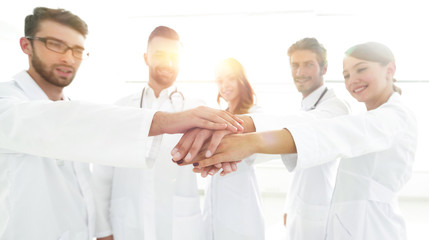 Fototapeta na wymiar Doctors and nurses in a medical team stacking hands