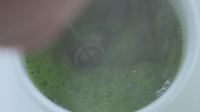 top view of cup with matcha tee preparation process