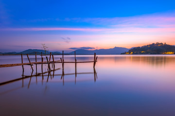 Fototapeta na wymiar The bamboo bridge on sunrise in Lak lake in Daklak province, Vietnam.