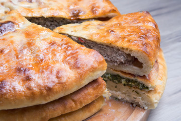 Traditional Ossetian pies. Three basic pies for the holiday. Close-up, selective focus.
