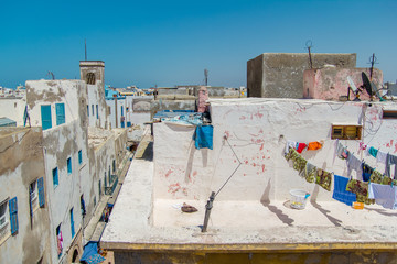 View over the roofs of houses with different clothes  after washing in the old arabic town of Essaouira, Morocco, Africa.