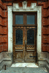 Fototapeta na wymiar Old vintage wooden door with glass and metal parts