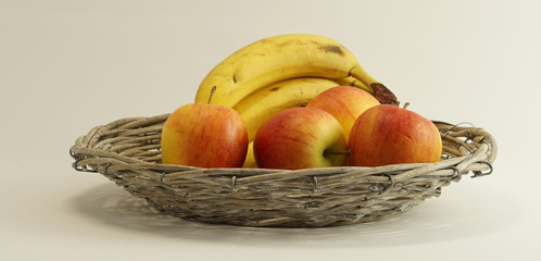 fresh ripe bio basket with bananas and apples