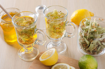 herbal tea with lemon and honey in a glass on a dark light background