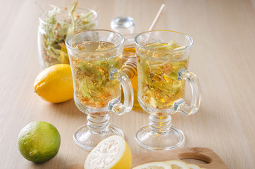 herbal tea with lemon and honey in a glass on a dark light background