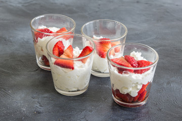 seasonal strawberries with cream and mint in glass cup