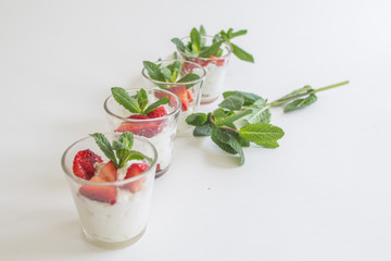 seasonal strawberries with cream and mint in glass cup