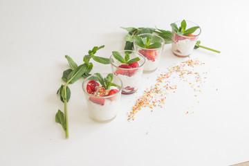 seasonal strawberries with cream and mint in glass cup