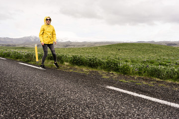 Woman walking funny down a road