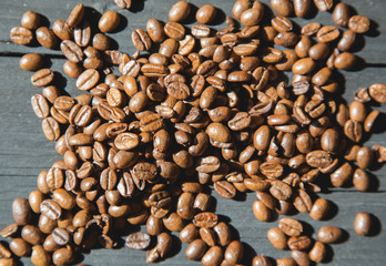 Coffee beans on black wooden background.