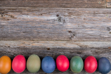 different easter eggs on gray wooden ground