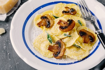ravioli pasta with champignon mushrooms and parmesan cheese