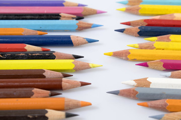 Colored pencils in a white background composition