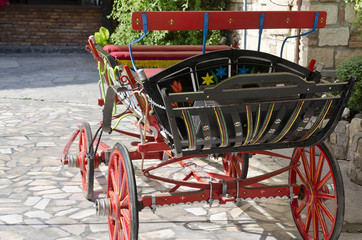 Fototapeta na wymiar One old made beautiful red cart wagon