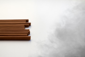 Brown cigarettes on white background.