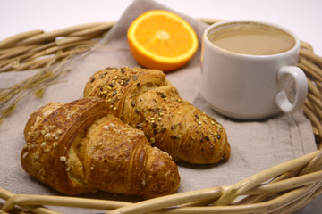 Croissants Cup of coffee and orange on a tray. Breakfast. Morning concept