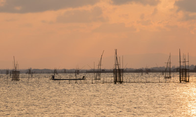 Fishing boat out to fish in sea waters at sunset,on sky colors beautiful    