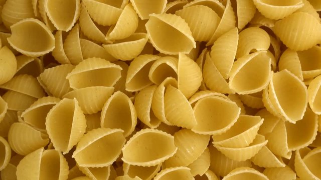 Raw conchiglie rigate closeup revolving on a turntable. Overhead view. Not loopable.